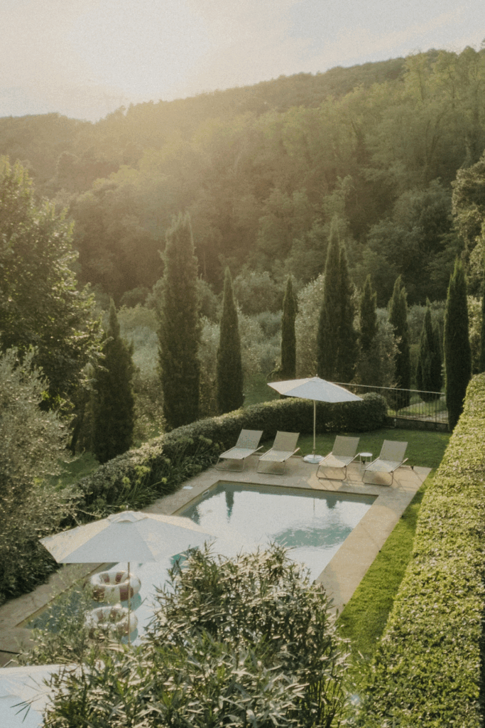 Overview of the pool at Casa Le Sorelle with the hills of Tuscany in the background